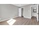 Bedroom featuring light walls, wood-look floors and closet at 7113 E Bell Cir, Mesa, AZ 85208