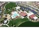 Aerial view of community pool, playground, green spaces, and parking at 7337 S Debra Dr, Gilbert, AZ 85298