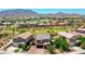 Expansive aerial view of a residential community with lush landscaping and mountain backdrop at 7337 S Debra Dr, Gilbert, AZ 85298