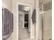 Bathroom view showcasing a glass-enclosed shower and an open doorway to a walk-in closet at 7337 S Debra Dr, Gilbert, AZ 85298