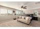 Bright bedroom featuring neutral walls, plush carpet, and a cozy chaise lounge for relaxation at 7337 S Debra Dr, Gilbert, AZ 85298