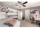 Stylish bedroom features gray and white striped walls, a ceiling fan, and a modern desk area at 7337 S Debra Dr, Gilbert, AZ 85298