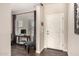 Stylish entryway featuring dark wood floors, a white door, and an adjacent home office space at 7337 S Debra Dr, Gilbert, AZ 85298