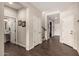 Bright hallway with dark wood floors, neutral walls, and doorways leading to various rooms at 7337 S Debra Dr, Gilbert, AZ 85298