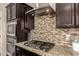 Close up of the kitchen featuring stainless appliances, granite counters, a range hood, and tiled backsplash at 7337 S Debra Dr, Gilbert, AZ 85298