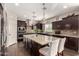 This spacious kitchen features dark cabinets, granite countertops, stainless appliances, and a large center island at 7337 S Debra Dr, Gilbert, AZ 85298