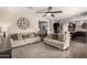 Open-concept living room with dark wood floors, comfortable seating, and seamless flow to the kitchen at 7337 S Debra Dr, Gilbert, AZ 85298