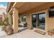 Relaxing covered patio with comfortable seating, string lights, and a sliding glass door to the indoors at 7337 S Debra Dr, Gilbert, AZ 85298