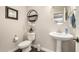 Neutral powder room with white fixtures, wood look floors, and modern décor for guests at 7337 S Debra Dr, Gilbert, AZ 85298