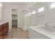 A bright bathroom features a tub, tiled shower and tile floors at 742 E Watermelon Ln, Queen Creek, AZ 85140