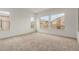 Bright bedroom featuring neutral carpet, white walls and three windows for ample natural light at 742 E Watermelon Ln, Queen Creek, AZ 85140