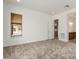 A spacious bedroom featuring neutral carpet, white walls and a large window at 742 E Watermelon Ln, Queen Creek, AZ 85140