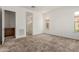 A spacious bedroom featuring neutral carpet, white walls and a large window overlooking the bathroom at 742 E Watermelon Ln, Queen Creek, AZ 85140