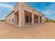 An exterior angle of the home shows the covered patio with the home's tan stucco finish at 742 E Watermelon Ln, Queen Creek, AZ 85140