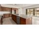 This kitchen features wood cabinets, granite counters and a center island with a sink and stainless dishwasher at 742 E Watermelon Ln, Queen Creek, AZ 85140