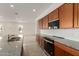 An open kitchen design featuring granite countertops, a large island and stainless steel appliances at 742 E Watermelon Ln, Queen Creek, AZ 85140