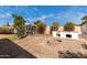 Backyard featuring a brick fire pit, chicken coop, and mature landscaping at 7458 E Clovis Cir, Mesa, AZ 85208