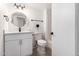 This bathroom features white cabinets, a round mirror, and a shower/tub combo at 7458 E Clovis Cir, Mesa, AZ 85208