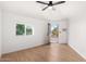 This bedroom features wood-look floors, a ceiling fan, and an exterior door at 7458 E Clovis Cir, Mesa, AZ 85208