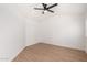 This bedroom features wood-look floors, a ceiling fan, and neutral walls at 7458 E Clovis Cir, Mesa, AZ 85208