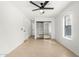 This bedroom has tile floors, a closet with mirrored doors, and a ceiling fan at 7458 E Clovis Cir, Mesa, AZ 85208