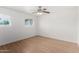 This bedroom features hardwood floors, a ceiling fan, and a large window for natural light at 7458 E Clovis Cir, Mesa, AZ 85208