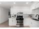 Bright kitchen with modern appliances, white cabinetry, and light countertops at 7458 E Clovis Cir, Mesa, AZ 85208