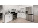 This kitchen features white cabinets, a black stove, and a stainless steel refrigerator at 7458 E Clovis Cir, Mesa, AZ 85208