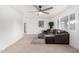 Bright living room with a ceiling fan, neutral décor, and tile flooring at 7458 E Clovis Cir, Mesa, AZ 85208