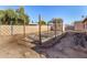 This backyard has metal garden beds and is surrounded by wooden fences with foliage at 8612 N 31St Ln, Phoenix, AZ 85051