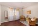 Comfortable bedroom featuring a large sunny window with decorative curtains at 8612 N 31St Ln, Phoenix, AZ 85051