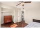 This bedroom features a ceiling fan, closet, a wooden dresser and an open doorway to the kitchen at 8612 N 31St Ln, Phoenix, AZ 85051