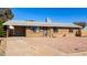 Inviting single-story brick home featuring neutral rock landscaping, a covered carport, and a welcoming entrance at 8612 N 31St Ln, Phoenix, AZ 85051