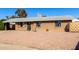 Welcoming single-story brick home boasting a low-maintenance rock front yard, covered carport, and classic design at 8612 N 31St Ln, Phoenix, AZ 85051