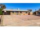 Charming single-story brick home with a low-maintenance, rockscaped front yard and a covered carport at 8612 N 31St Ln, Phoenix, AZ 85051