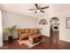 Comfortable living room features wood floors, ceiling fan and an archway to the second living space at 8612 N 31St Ln, Phoenix, AZ 85051