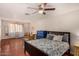 Spacious main bedroom with a ceiling fan, wooden floors and a large blue dresser at 8612 N 31St Ln, Phoenix, AZ 85051