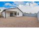 This spacious gravel backyard features a block wall, a covered patio, and a view of the house at 8826 W Amelia Ave, Phoenix, AZ 85037