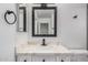 The bathroom features a single sink vanity and modern black fixtures at 8826 W Amelia Ave, Phoenix, AZ 85037