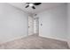 A light and airy bedroom with wood look floors, a ceiling fan, and an open doorway at 8826 W Amelia Ave, Phoenix, AZ 85037