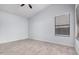 A bright bedroom featuring light colored wood look floors and a ceiling fan at 8826 W Amelia Ave, Phoenix, AZ 85037