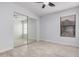 A bedroom with mirrored closet doors, light colored wood look floors, and a ceiling fan at 8826 W Amelia Ave, Phoenix, AZ 85037