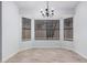 Dining area featuring a chandelier fixture and natural lighting from surrounding windows at 8826 W Amelia Ave, Phoenix, AZ 85037