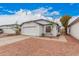 Front exterior view showing a 2-car garage, desert landscaping and a well-maintained home at 8826 W Amelia Ave, Phoenix, AZ 85037