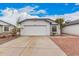 Charming single-story home with a two-car garage, manicured landscaping, and a well-maintained front yard at 8826 W Amelia Ave, Phoenix, AZ 85037