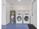 The laundry room features a water heater and side-by-side washer and dryer units, with a blue painted floor at 8826 W Amelia Ave, Phoenix, AZ 85037