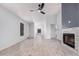 Bright, open-concept living space with tile floors, a fireplace, and neutral color palette at 8826 W Amelia Ave, Phoenix, AZ 85037