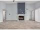 Bright, airy living room featuring a fireplace with stone accents and light wood-look flooring at 8826 W Amelia Ave, Phoenix, AZ 85037