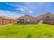 Wide-open backyard with lush green grass and a charming covered patio for relaxation at 9734 W Carol Ave, Peoria, AZ 85345