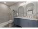 A bright bathroom featuring double sinks and a tile shower at 9734 W Carol Ave, Peoria, AZ 85345